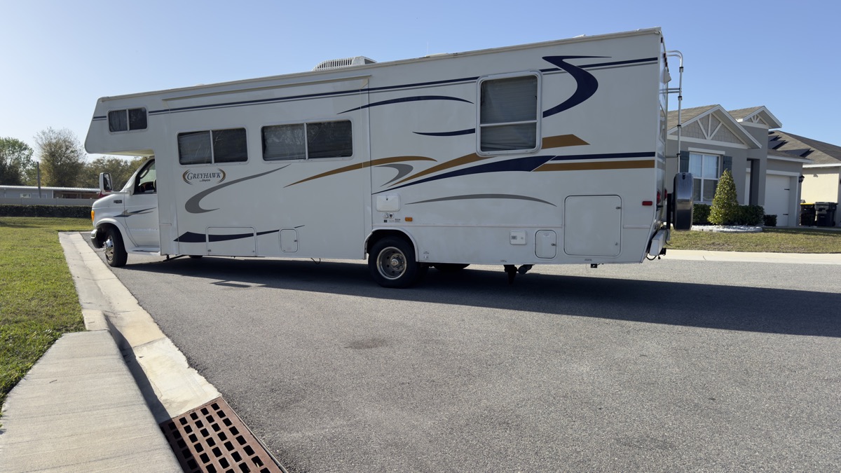 Class C motorhome bought for cash, rear three-quarter view — serving Florida