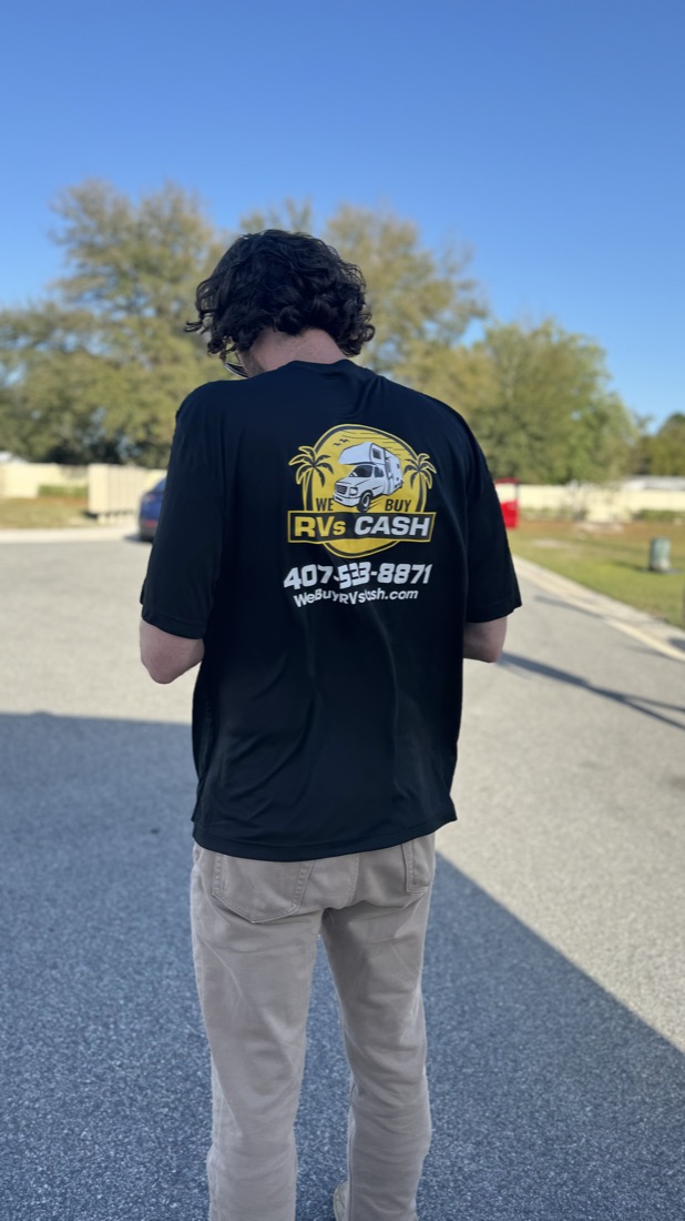 The buyer from We Buy RVs Cash with the company sign behind him — serving Daytona Beach